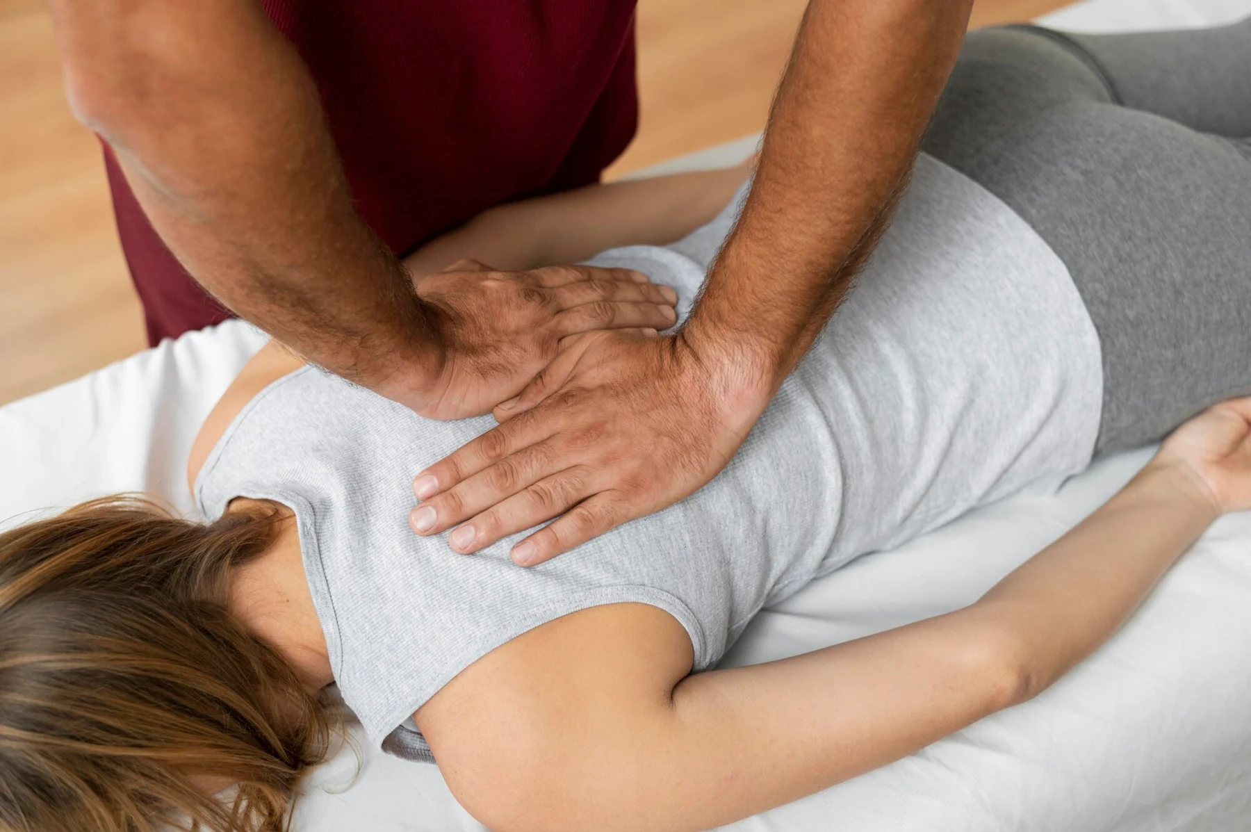 Hands-on chiropractic treatment with a patient lying on their side