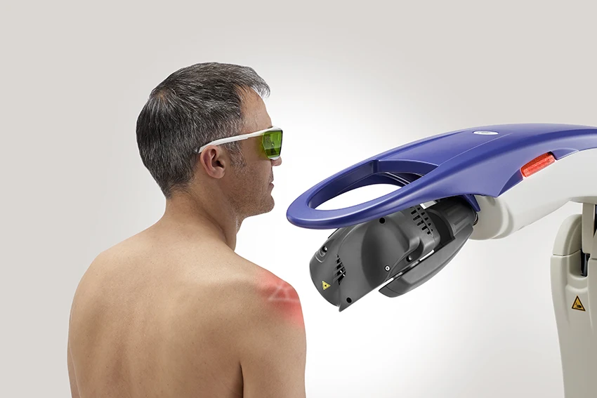 Patient wearing protective glasses during MLS laser treatment of the upper back